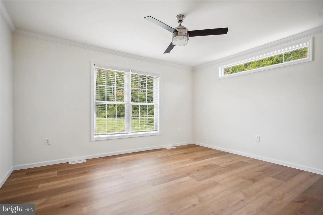 10 Ginger Lane Conowingo, MD 21918 - Photo 26 of 34 an empty room with wooden floor fan and windows