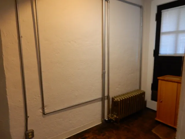 a view of a hallway with a refrigerator