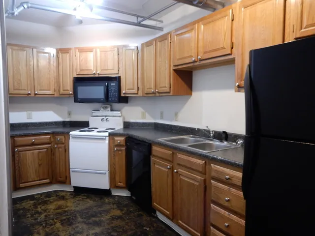 a kitchen with a sink stove and microwave