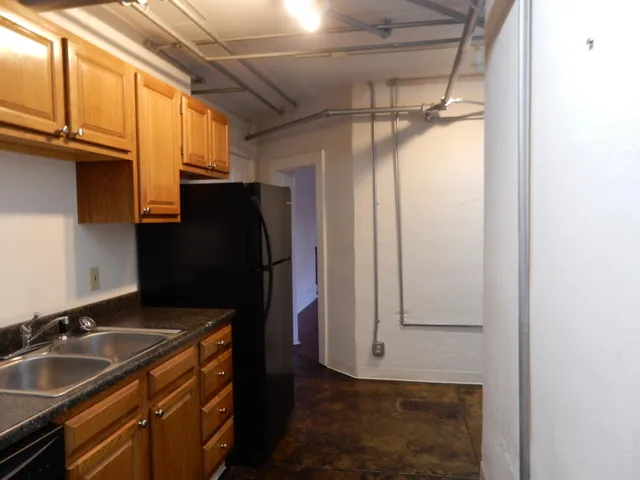 a kitchen with a refrigerator and a sink