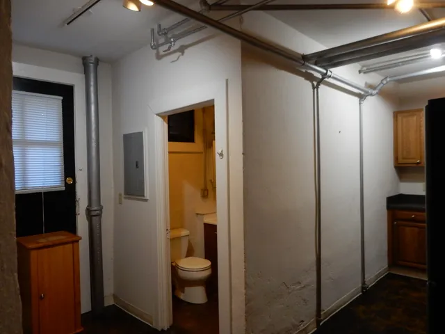 a bathroom with a toilet and a shower