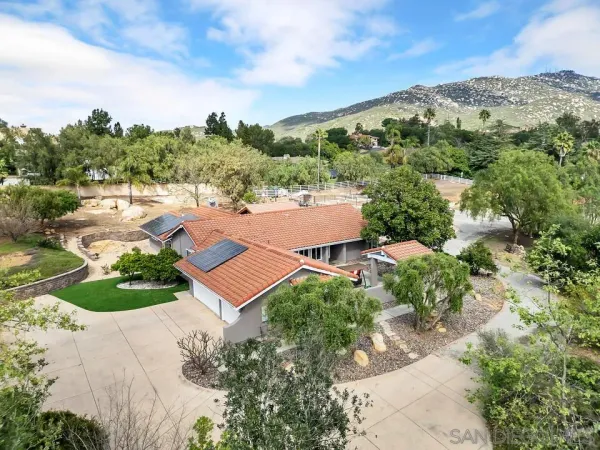 an aerial view of a house with garden space and street view