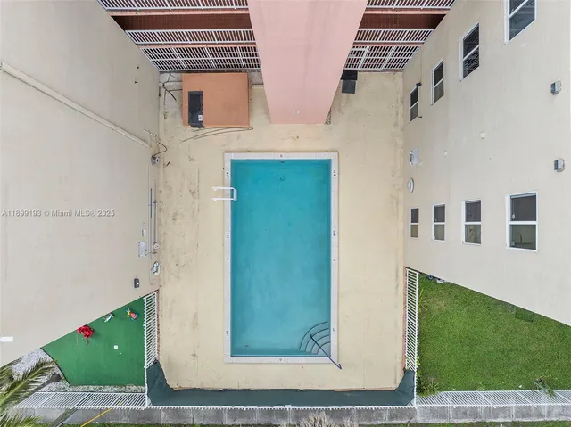 an aerial view of a house with a yard and lake view