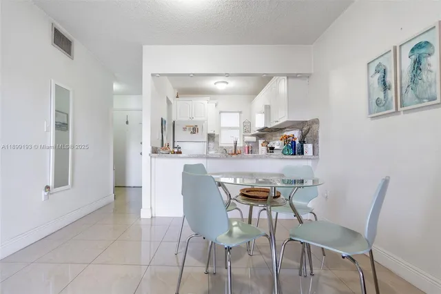 a living room with furniture and a view of kitchen