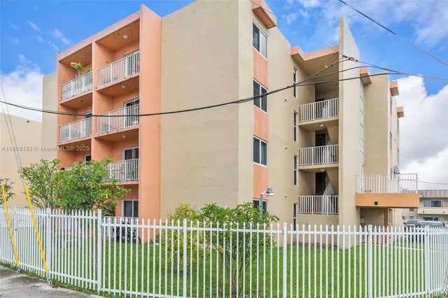 a view of a brick building next to a yard