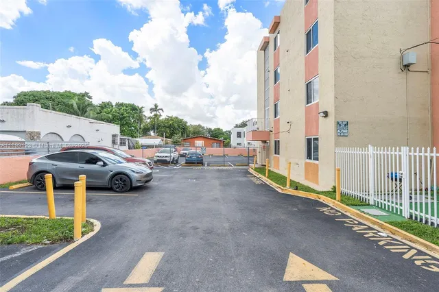 a view of a street with cars parked