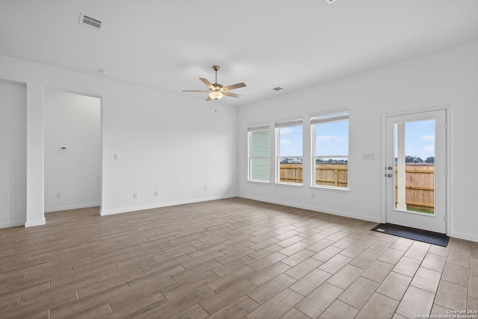 5755 Musquiz Ridge Seguin, TX 78155 - Photo 10 of 31 a view of an empty room with a window and wooden floor