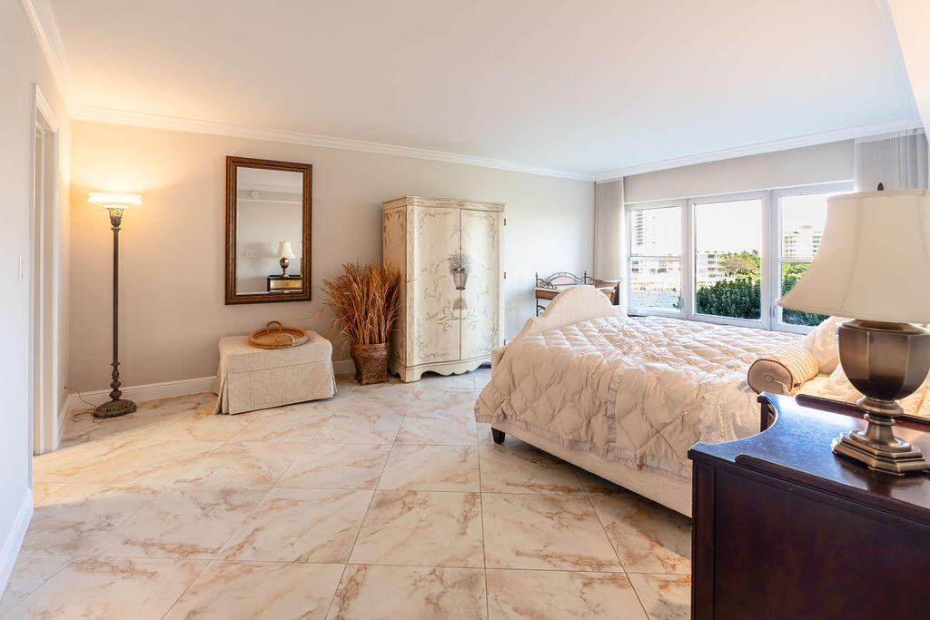 875 East Camino Real Boca Raton, FL 33432 - Photo 17 of 31 a bedroom with a bed and window