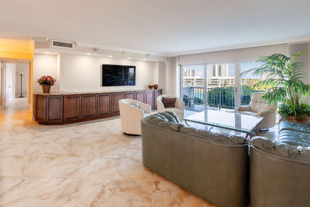 875 East Camino Real Boca Raton, FL 33432 - Photo 3 of 31 a living room with furniture and a flat screen tv