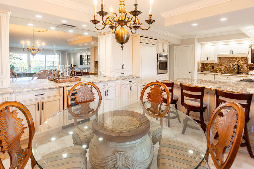 875 East Camino Real Boca Raton, FL 33432 - Photo 9 of 31 a very nice looking dining room with a large window with kitchen view