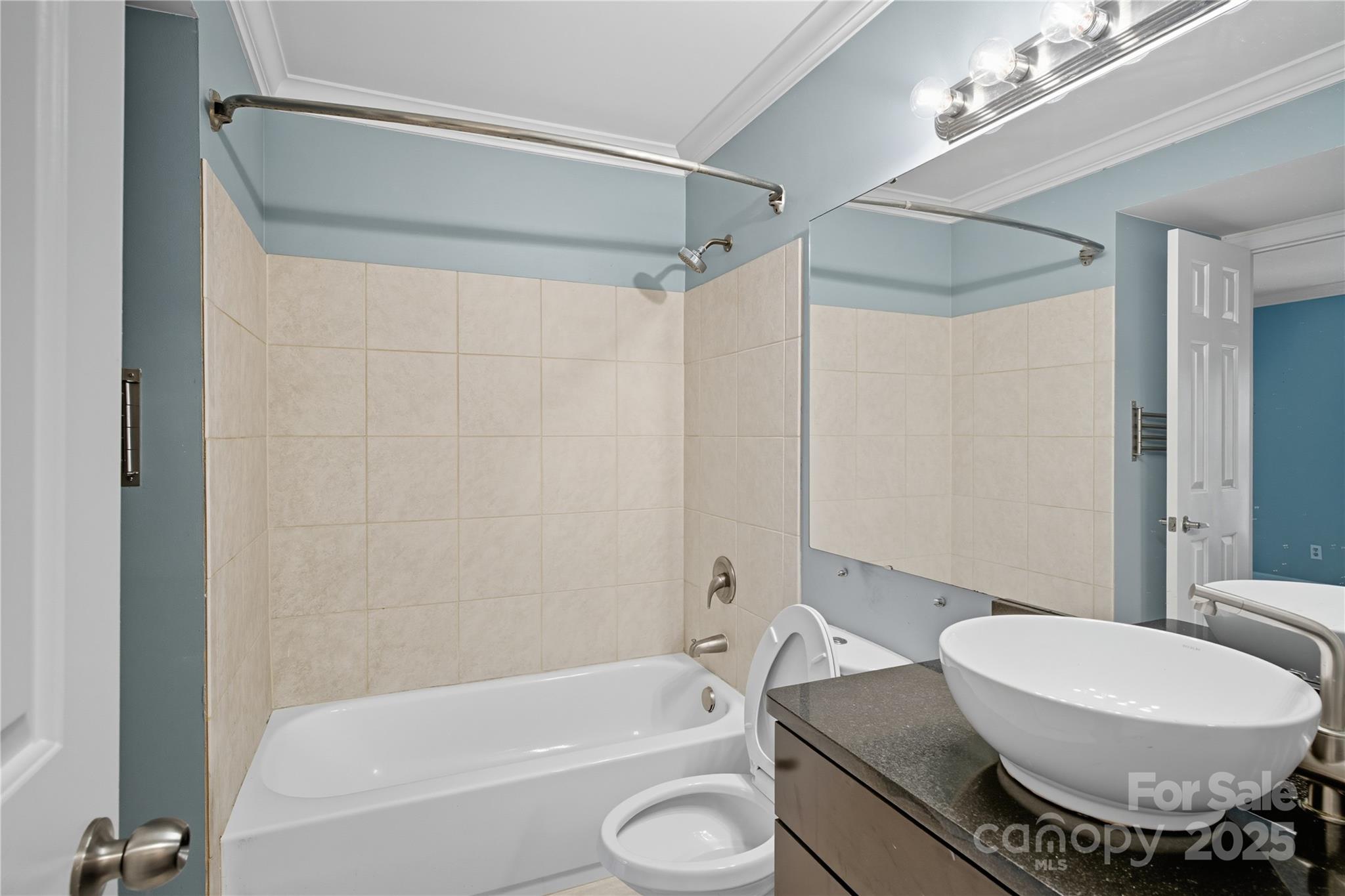 509 North Graham Street, Unit 3J Charlotte, NC 28202 - Photo 13 of 32 a bathroom with a toilet sink and shower