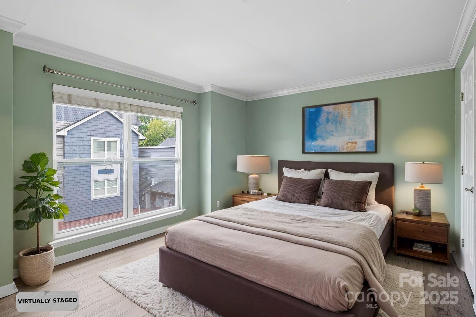 509 North Graham Street, Unit 3J Charlotte, NC 28202 - Photo 14 of 32 a bedroom with a large bed and a potted plant