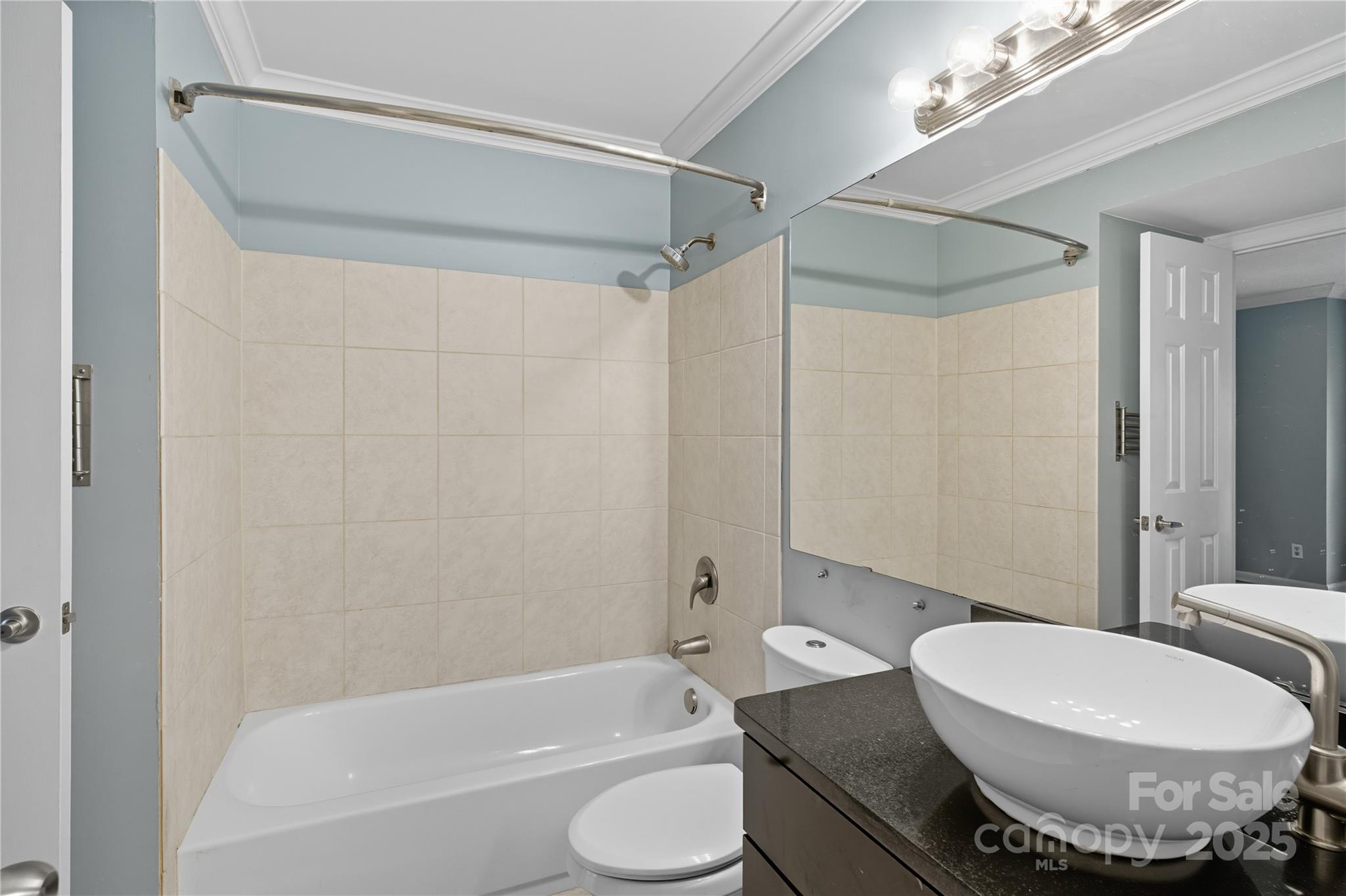 509 North Graham Street, Unit 3J Charlotte, NC 28202 - Photo 25 of 32 a bathroom with a toilet and a shower