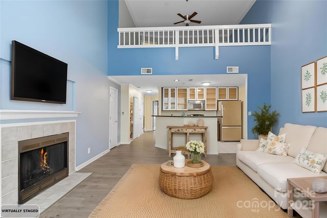 a living room with furniture a fireplace and a flat screen tv