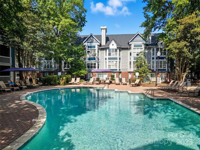 a view of a house with swimming pool and sitting area