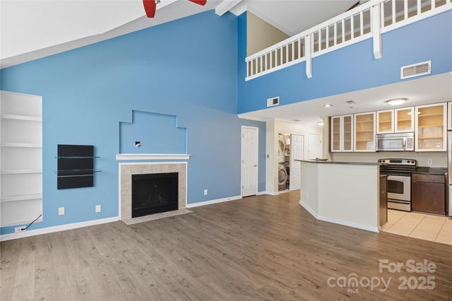 a view of kitchen with granite countertop cabinets and stainless steel appliances
