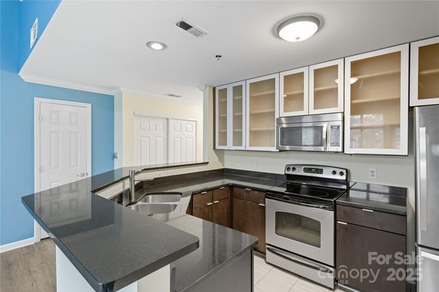 a kitchen that has a sink and a stove