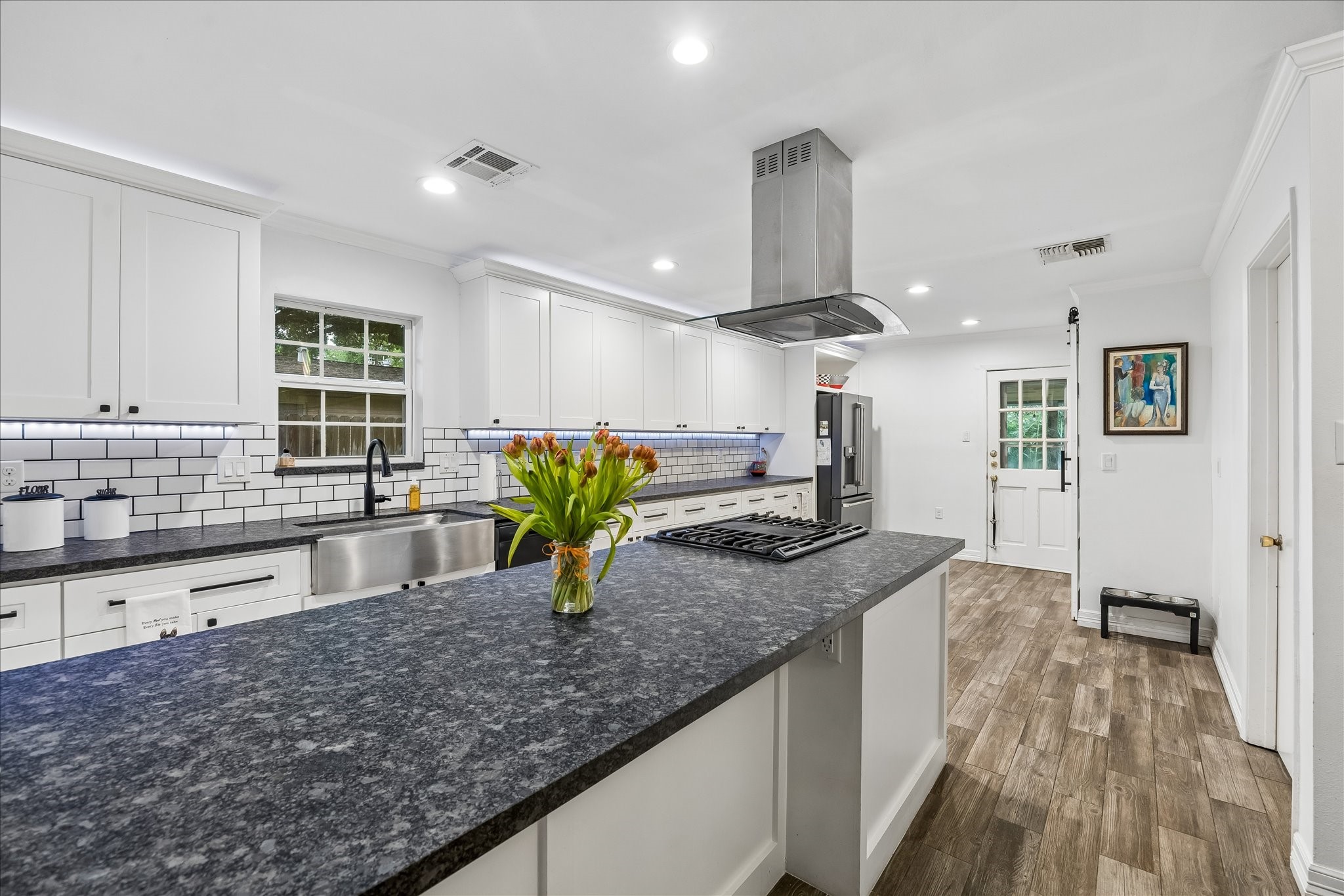 5526 Grape Street Houston, TX 77096 - Photo 3 of 10 a large kitchen with granite countertop a sink a counter top space and stainless steel appliances