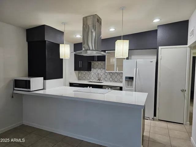 a kitchen with stainless steel appliances a refrigerator and cabinets