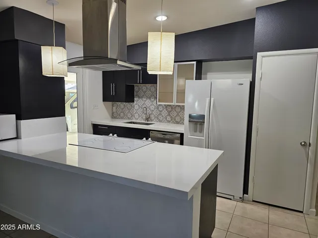 a kitchen with a stove cabinets and wooden floor