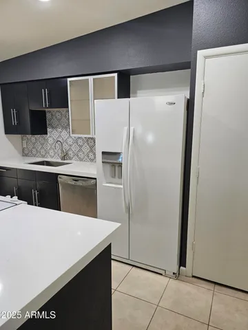 a view of an empty room with a fireplace and a window
