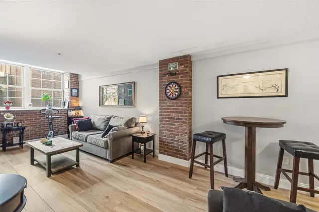 a living room with furniture a rug and a window