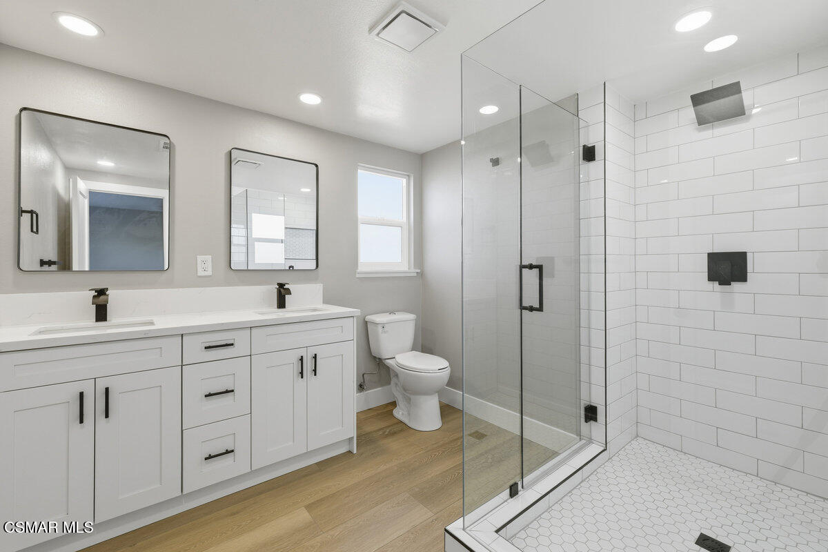 1069 Donner Avenue Simi Valley, CA 93065 - Photo 11 of 24 a spacious bathroom with a shower sink and mirror