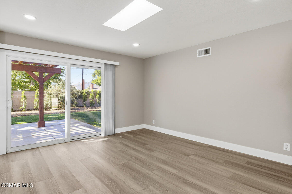 1069 Donner Avenue Simi Valley, CA 93065 - Photo 7 of 24 an empty room with wooden floor and windows