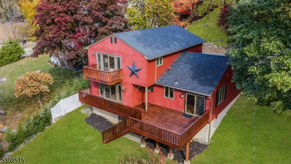 an aerial view of a house with a lake view