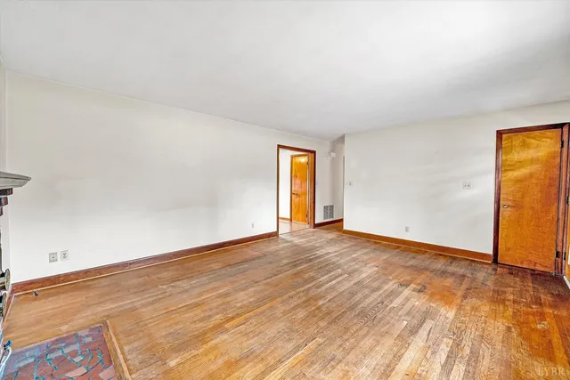a view of an empty room and wooden floor