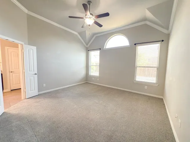 an empty room with closet and a ceiling fan
