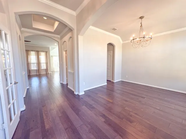 a view of a room with wooden floor