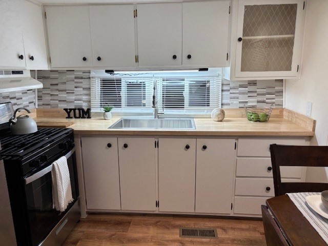 229 Miller Street, Unit B2 Ludlow, MA 01056 - Photo 5 of 22 a kitchen with granite countertop a stove sink and cabinets