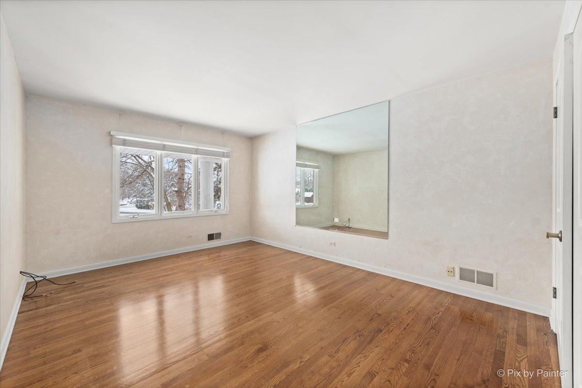 274 Timber View Drive Oak Brook, IL 60523 - Photo 32 of 68 an empty room with wooden floor and windows
