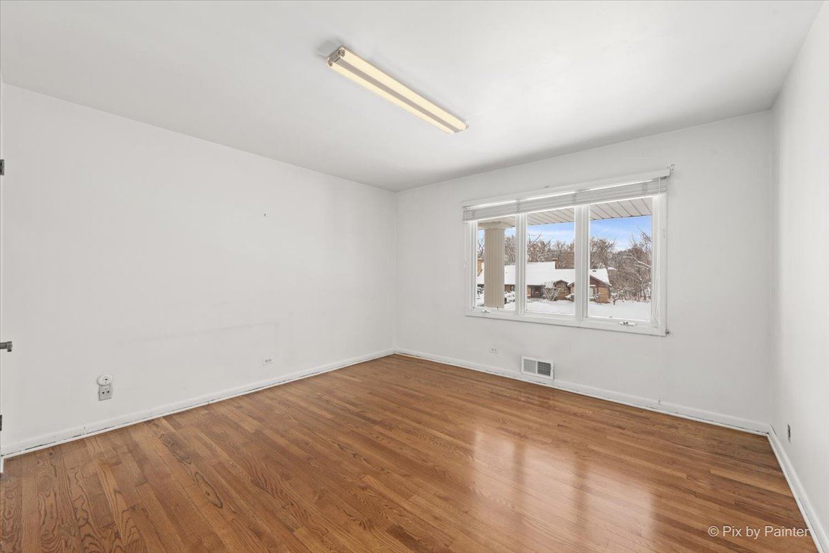 274 Timber View Drive Oak Brook, IL 60523 - Photo 34 of 68 a view of an empty room with wooden floor and a window