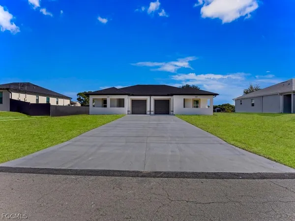 a view of house with yard and green space