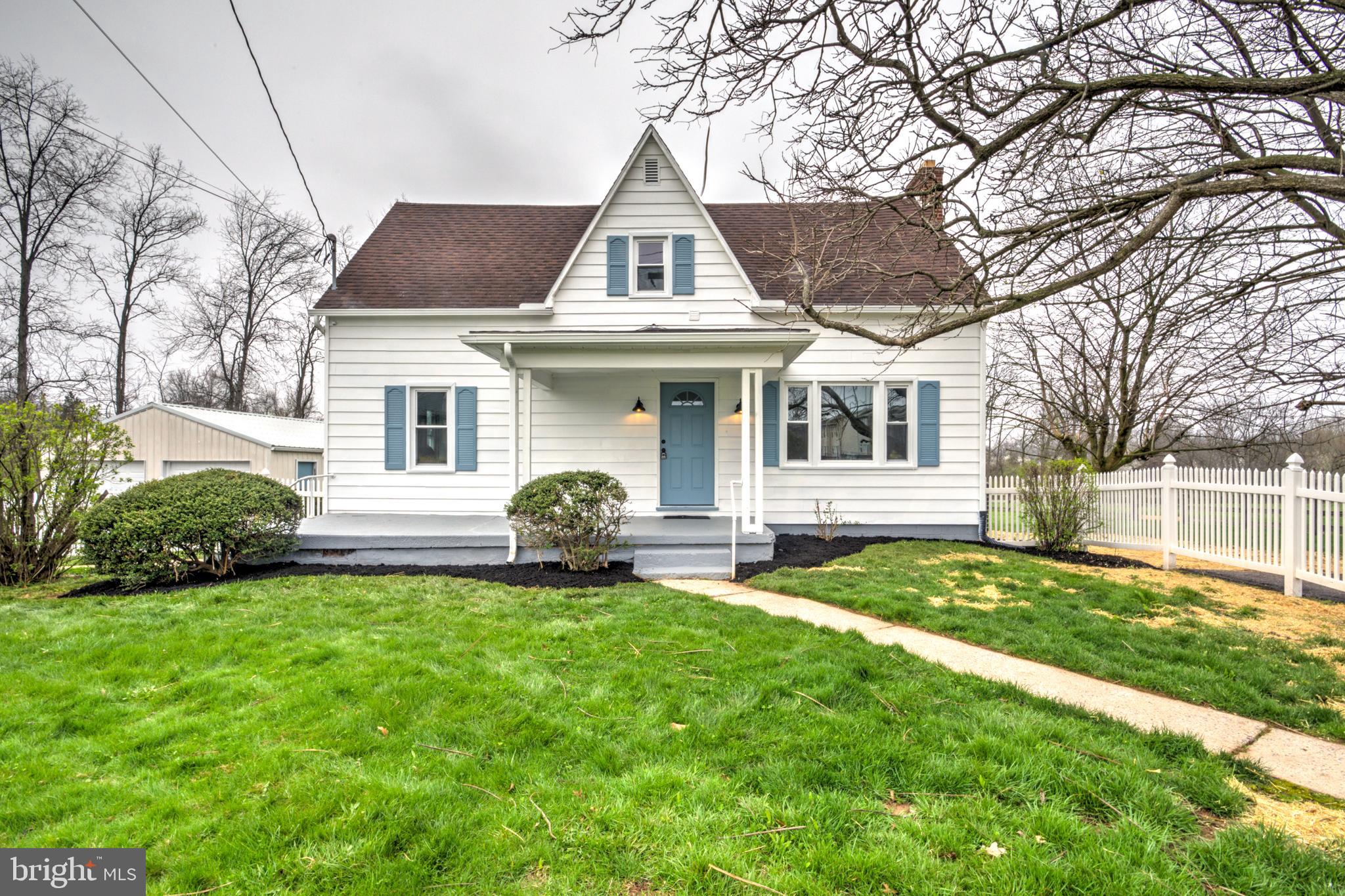 a front view of a house with a garden and yard
