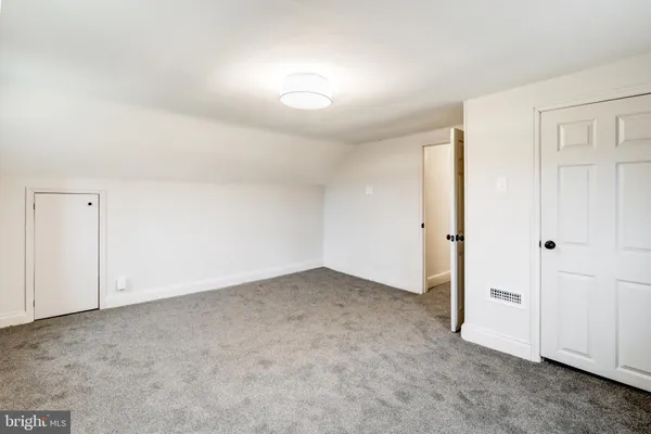 an empty room with closet area