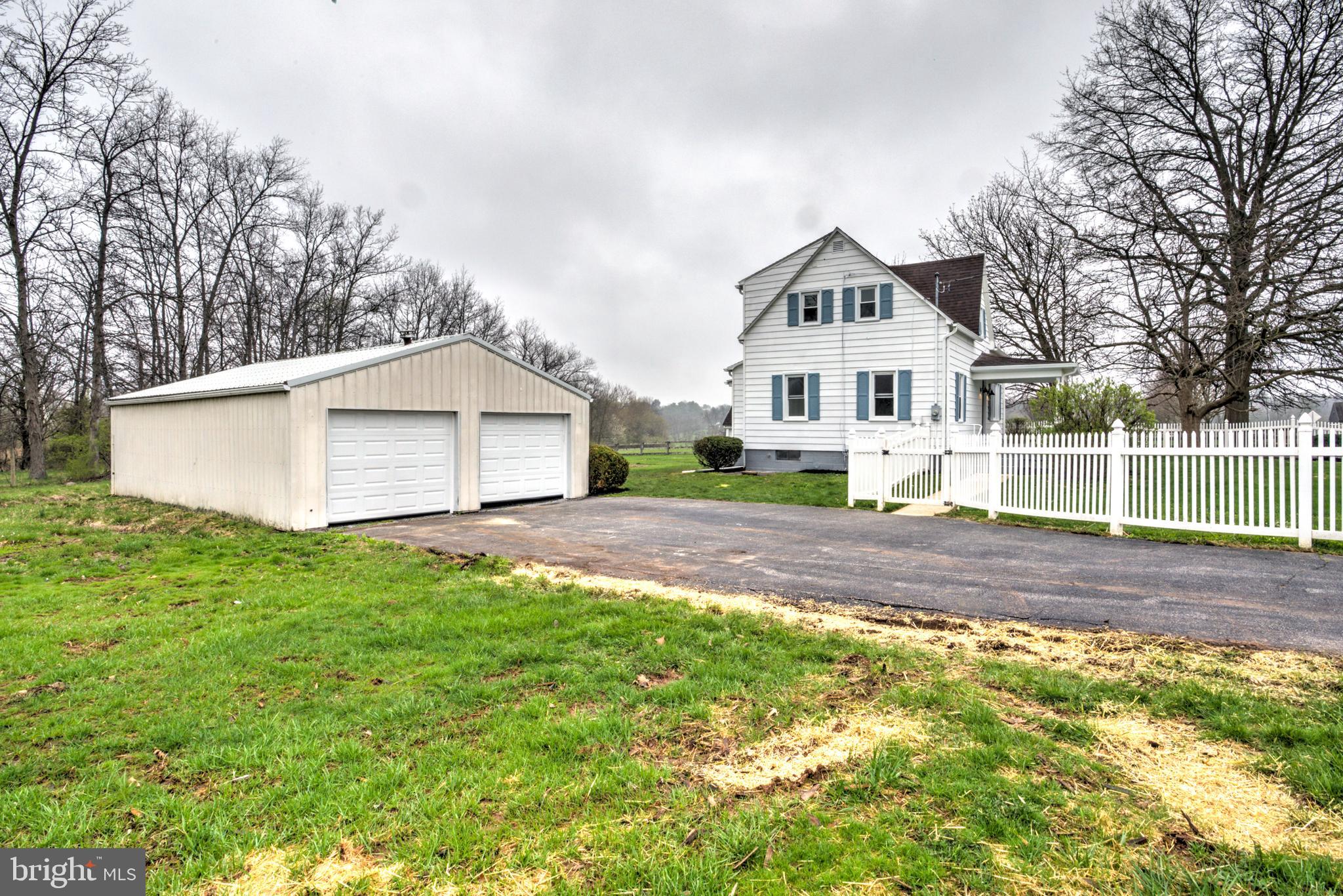 1965 Greenbriar Road York, PA 17404 - Photo 35 of 37 a front view of a house with a yard and garage
