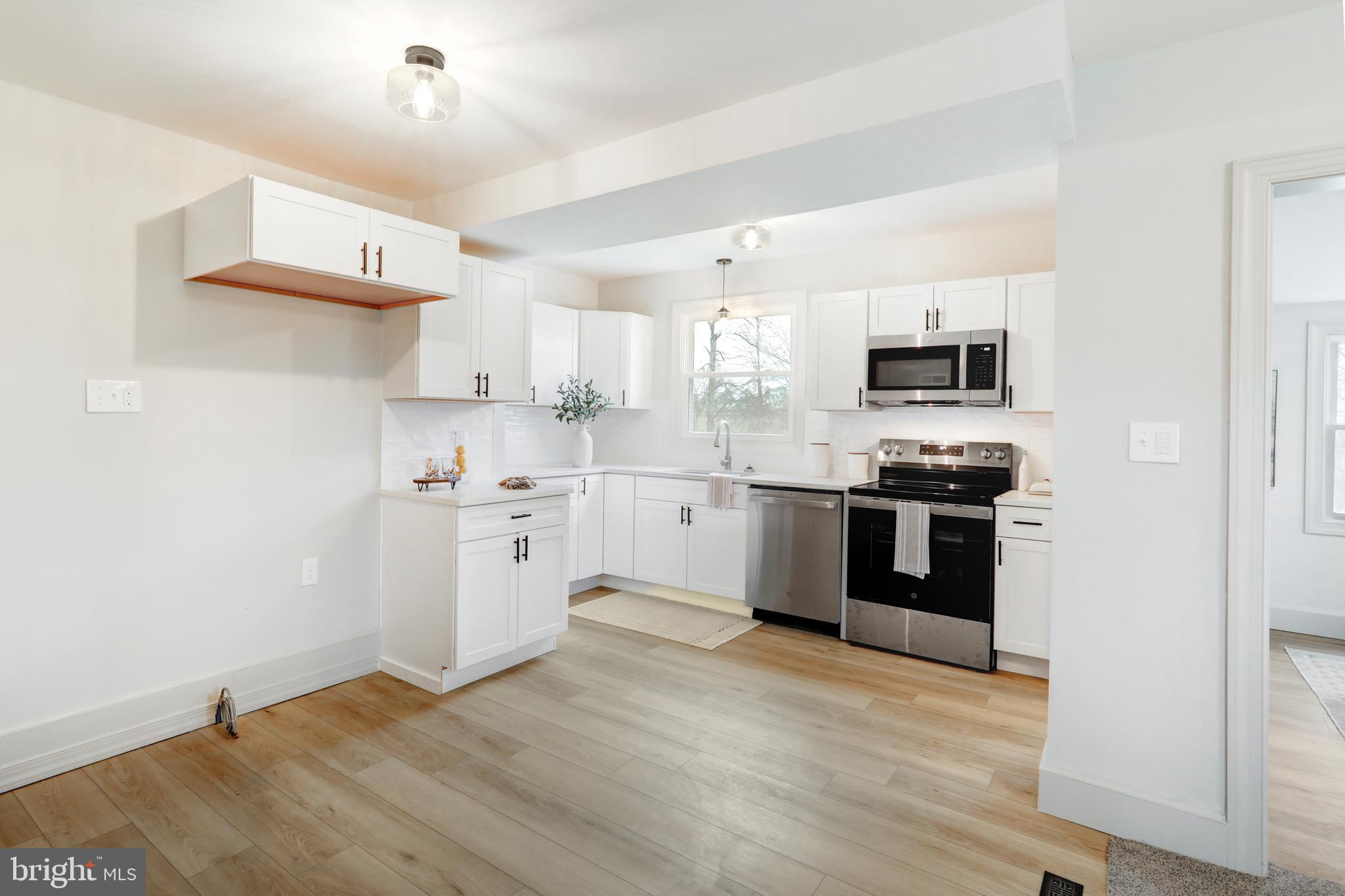 1965 Greenbriar Road York, PA 17404 - Photo 5 of 37 a kitchen with a sink cabinets and wooden floor