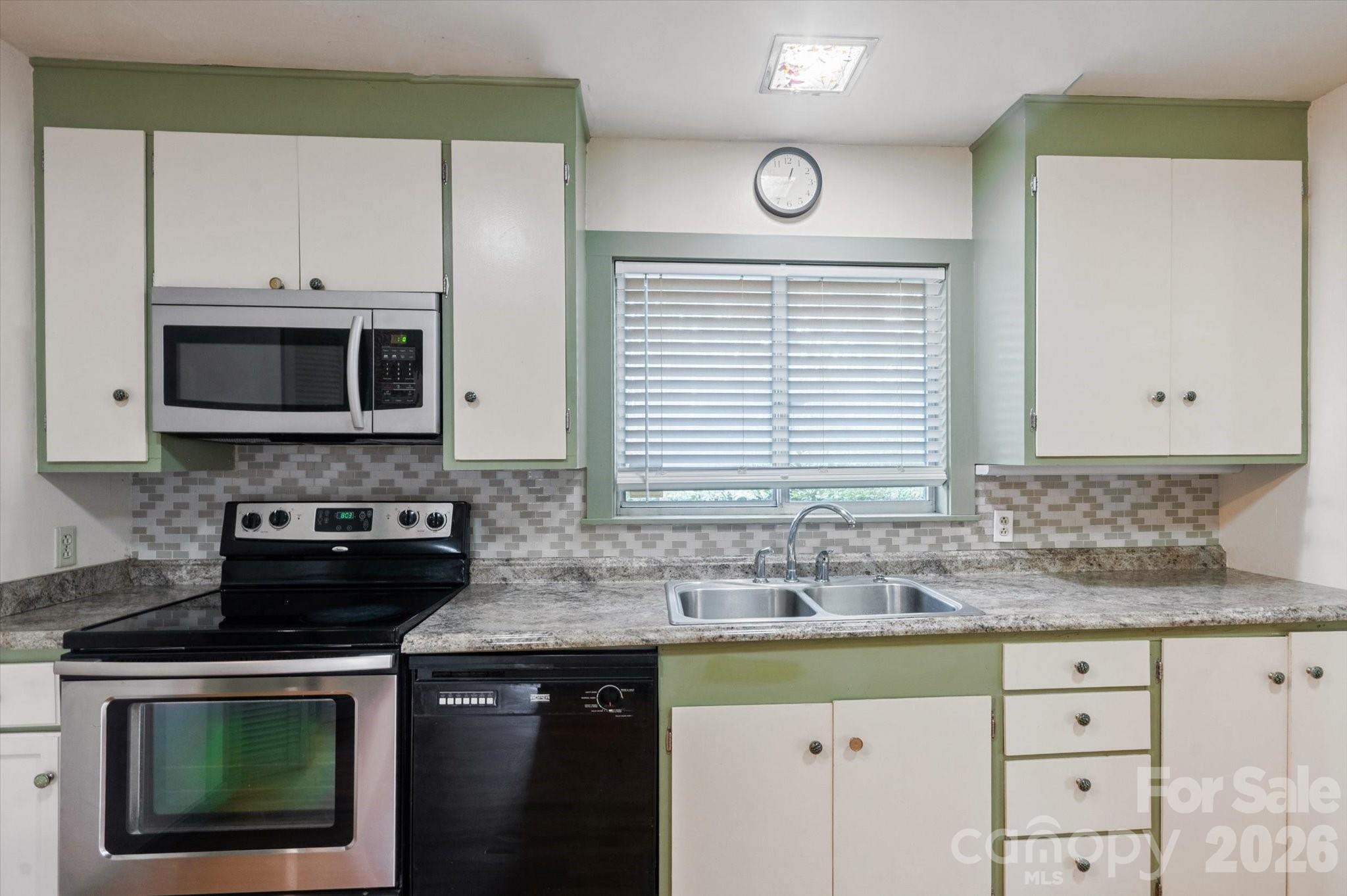 277 Fairlane Road Columbus, NC 28722 - Photo 14 of 25 a kitchen with stainless steel appliances granite countertop a sink stove and microwave