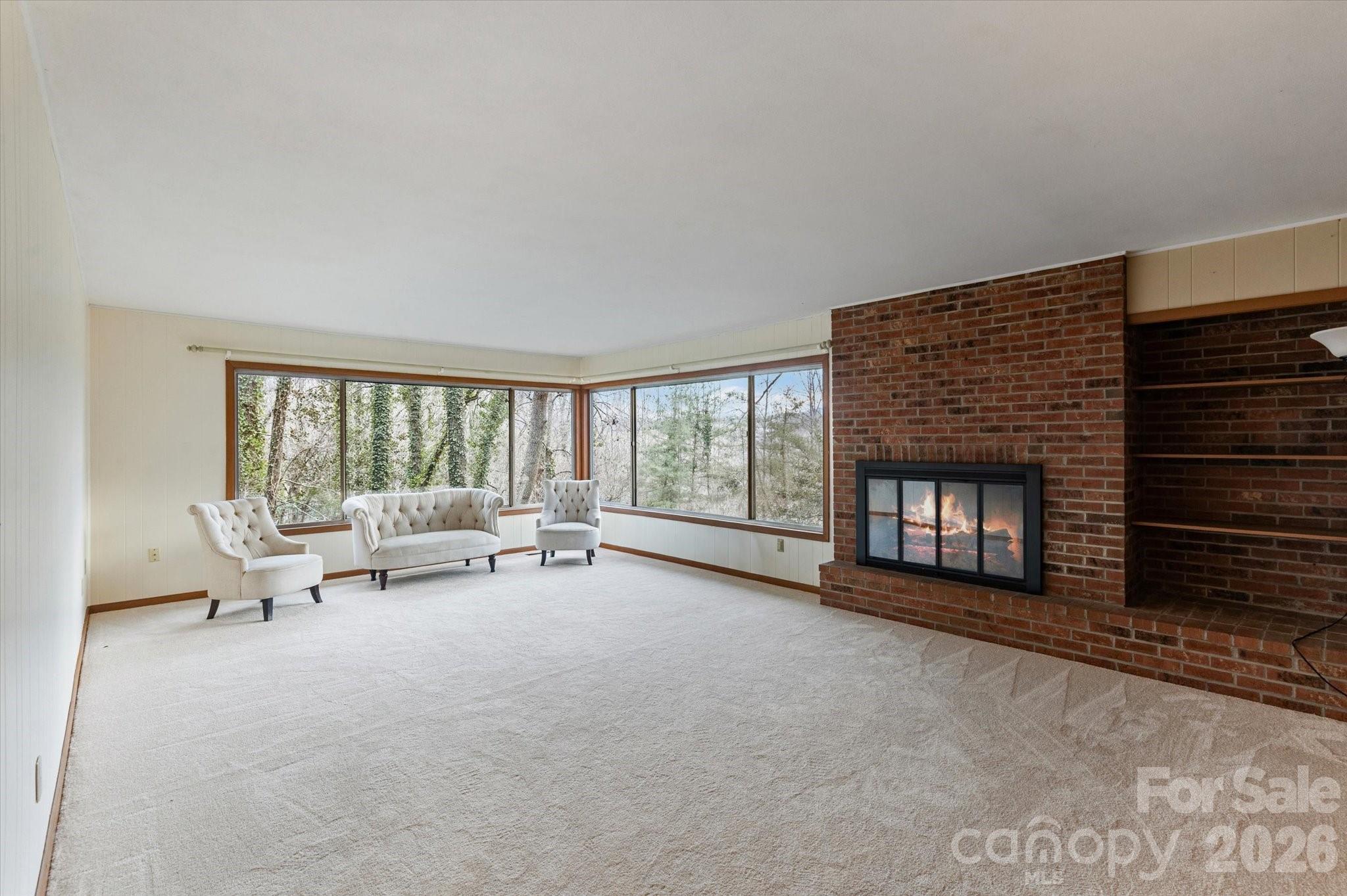 277 Fairlane Road Columbus, NC 28722 - Photo 5 of 25 a living room with furniture and a fireplace