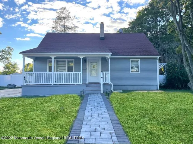 a front view of a house with a garden and yard