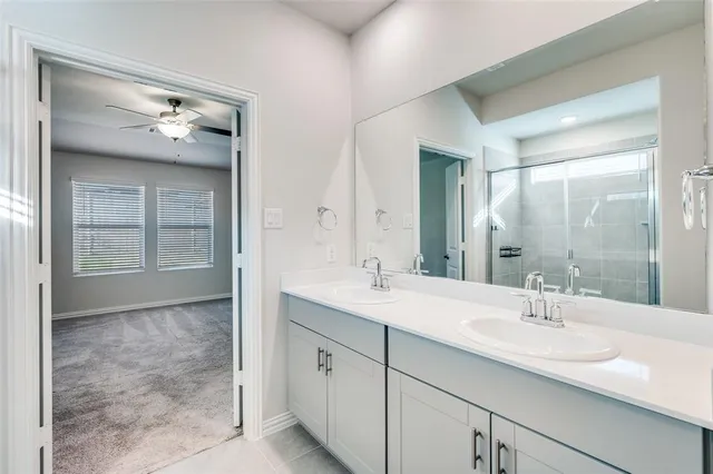 a bathroom with double sink and a mirror