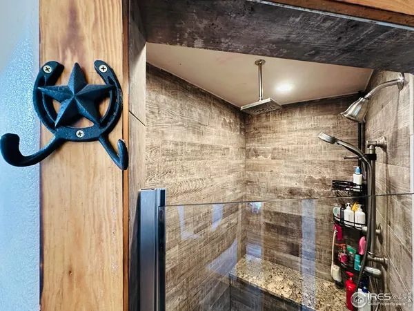a bathroom with a granite countertop shower a sink and a mirror