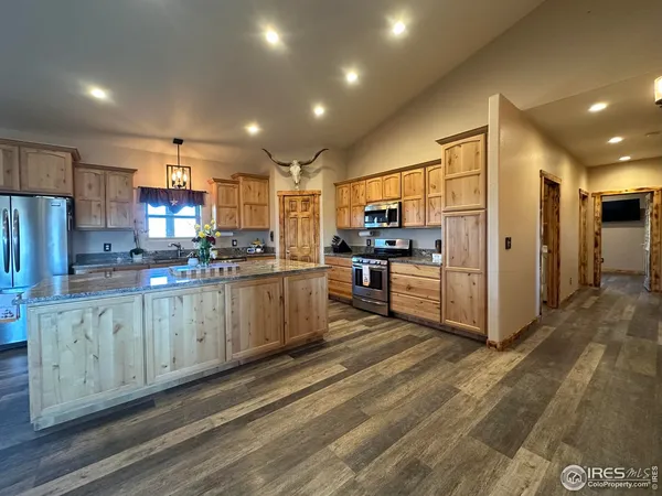 a kitchen with a refrigerator and a counter top space