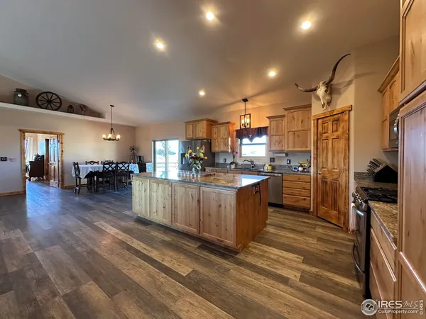 a kitchen with granite countertop a sink stainless steel appliances and cabinets