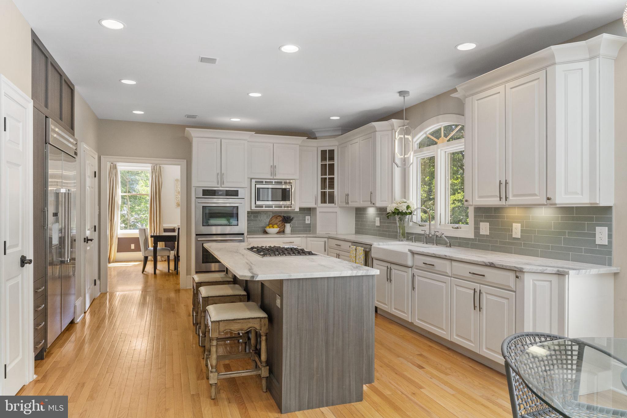 1122 King Of Prussia Road Wayne, PA 19087 - Photo 12 of 33 a kitchen with stainless steel appliances granite countertop a table chairs sink refrigerator and cabinets