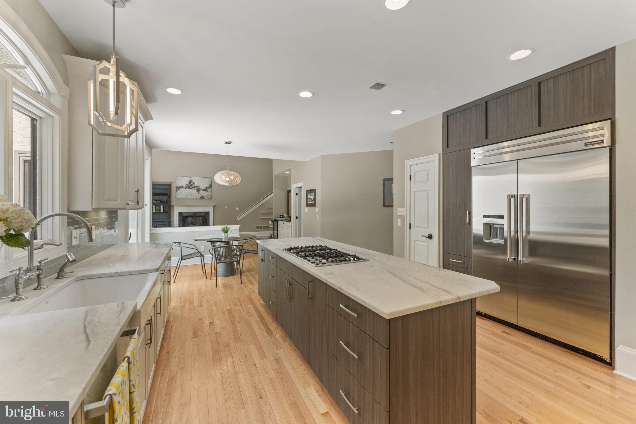 1122 King Of Prussia Road Wayne, PA 19087 - Photo 14 of 33 a kitchen with counter top space a sink a refrigerator and wooden floor