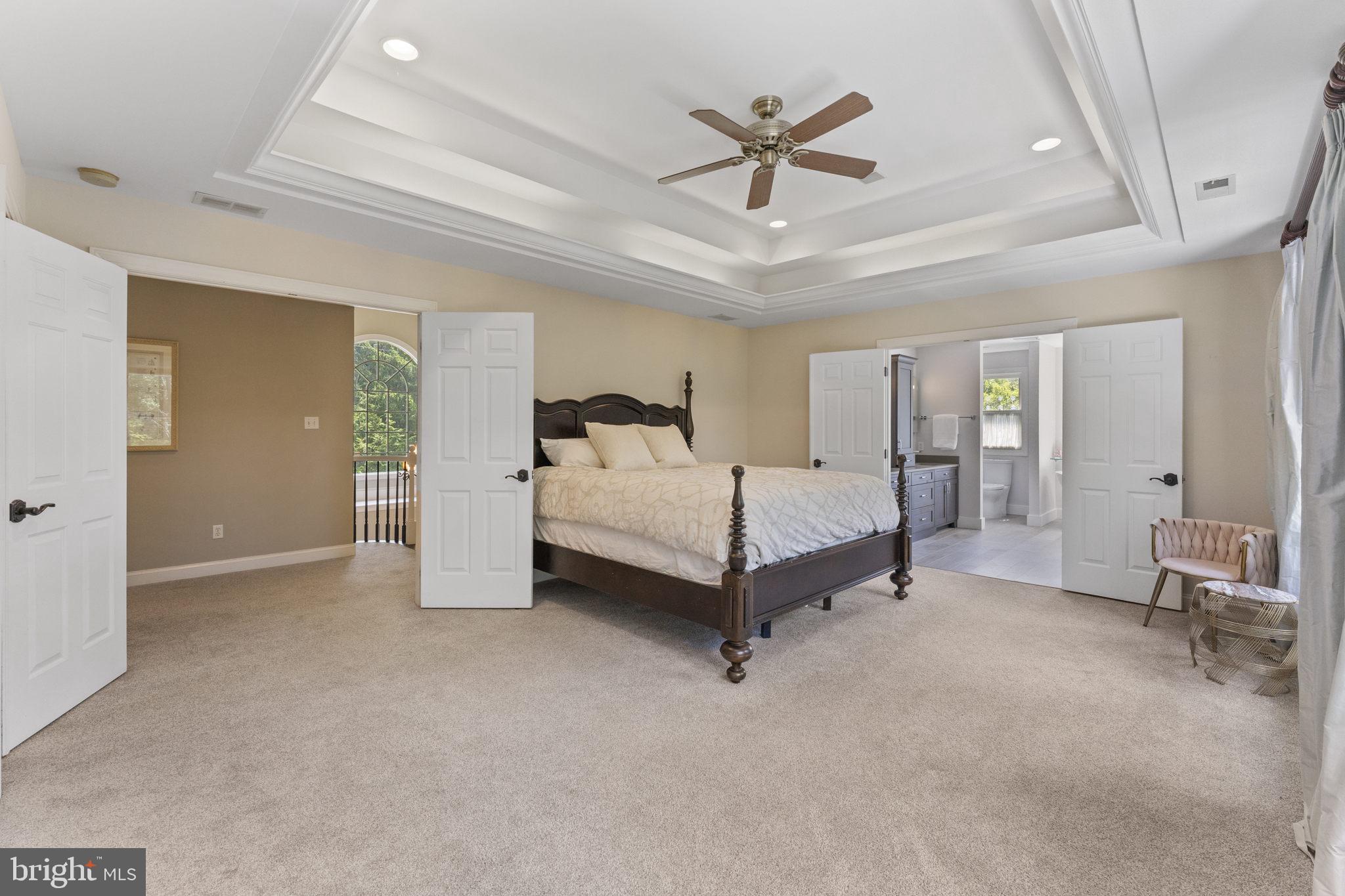 1122 King Of Prussia Road Wayne, PA 19087 - Photo 17 of 33 a spacious bedroom with a bed and a chandelier